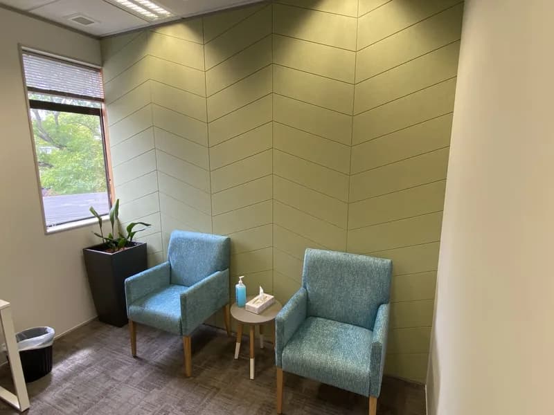Waiting room with chevron-laid Groove acoustic wall panels and teal seating, St George Hospital